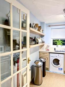 a kitchen with a pantry door with a trash can at Immaculate 2-Bed Apartment in Rochester in Rochester