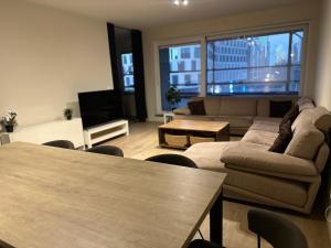 a living room with a couch and a table at Apartment in Brussels City with Beautiful View in Brussels