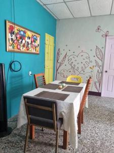 a dining room with a table with chairs and a painting at Casa La Ermita in San Benito