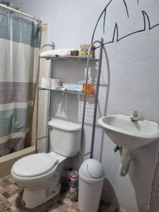 a bathroom with a toilet and a sink at Casa La Ermita in San Benito