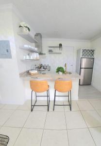 a kitchen with two chairs and a kitchen island at Studio furnished in Kissimmee