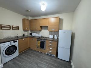 a kitchen with a washing machine and a washer at Modern Penthouse - 2 Bed, 2 Bath, 2 Gated Parking in Wellingborough