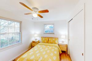 a bedroom with a bed and a ceiling fan at Schmitz Park Corner in Seattle