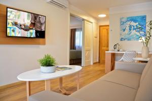 a living room with a couch and a table at Alua Suites Fuerteventura - All Inclusive in Corralejo
