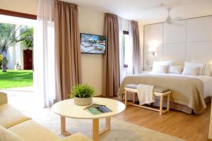 a hotel room with a bed and a table at Alua Suites Fuerteventura - All Inclusive in Corralejo