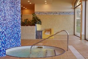 a hot tub in a room with blue tiles at Secrets Bahía Real Resort & Spa Adults only in Corralejo