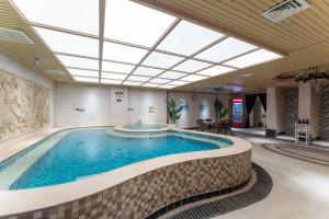 a large swimming pool in a building with a ceiling at Holiday Inn Taiyuan Sunshine, an IHG Hotel in Taiyuan