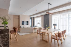 a dining room and living room with a table and chairs at Holiday Inn Taiyuan Sunshine, an IHG Hotel in Taiyuan