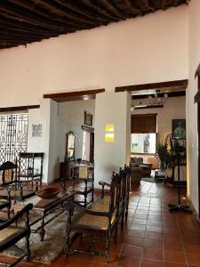 a room with a table and chairs and a living room at HOTEL CASA ALEMAN EN MOMPOX CON PARQUEADERO Y PISCINA CENTRO HISTORICOo in Mompós