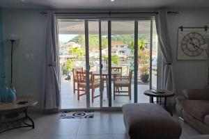 a living room with a view of a table and chairs at Beautifully renovated villa close to the beach in Jolly Harbour +6 photos