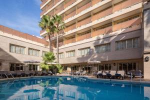 a swimming pool in front of a building at htop Amaika 4Sup - Adults Only #htopBliss in Calella