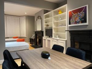 a room with a table and a bed and a fireplace at Home in Greenwich near the O2 in London