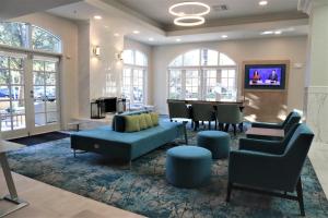 a living room with a couch and chairs and a table at Hilton Garden Inn Calabasas in Calabasas