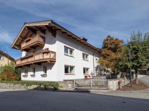 Casa blanca con balcones de madera en una calle en Föchlhaus am Marktgraben, en Hopfgarten im Brixental