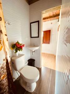 a bathroom with a toilet and a sink at Cabañas Iracas del Mar in Nuquí