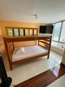 a bedroom with two bunk beds in a room at La Casa del Conde in San Gil