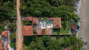 an overhead view of a house with red roof at Refugio de piedra - Troncones in Troncones +104 photos