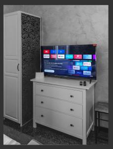 a dresser with a pile of boxes on top of it at Grazioso Monolocale Acquario a 100m free WI-FI in Genova