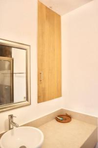 a white bathroom with a sink and a mirror at Cozy beach studio,5min walking to La IslaPlaza 11 - Mar11 - in Cancún