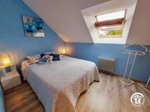 een slaapkamer met een bed en een blauwe muur bij Gîte Carelles, 7 pièces, 12 personnes - FR-1-600-62 in Carelles