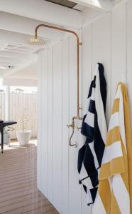 a room with a door with towels hanging on it at By the Bay - 100m to Beach in Rosebud
