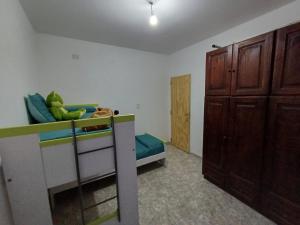 a bedroom with a bunk bed and a closet at Dpto Lu 2 in Villa Mercedes