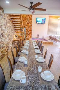a long table with chairs and plates on it at La Ocotera Hotel De Montaña in San Marcos