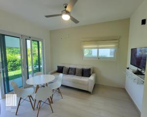 a living room with a couch and a table and chairs at 2JA Management Group - Condos White Hill in Sosúa
