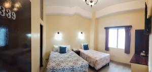 En eller flere senge i et værelse på Hotel Sevilla