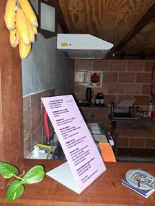 a piece of paper on a table in a kitchen at Casa de Praia - meu lugar em Iriri in Anchieta