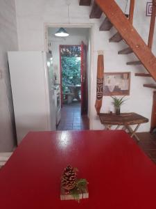 uma sala de jantar com uma mesa vermelha e uma escada em Alojamiento por día Merlo San Luis em Merlo