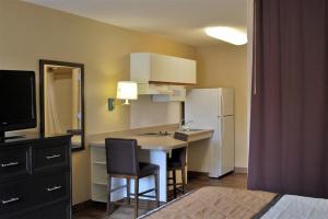 a small kitchen with a table and a refrigerator at Southfield Stay in Southfield