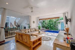 a living room with a couch and a table at 5 Bedroom Villa in Centre Location of Seminyak in Seminyak