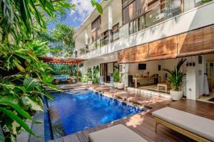 an indoor pool in a house with plants at 5 Bedroom Villa in Centre Location of Seminyak in Seminyak