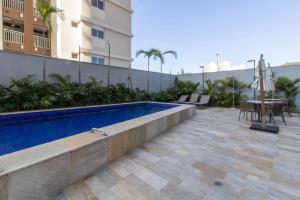 a swimming pool in front of a building at Patteo Charm Apartment - GRU 1003 in Guarulhos
