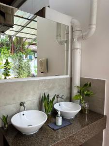 a bathroom with two sinks and a mirror at Mclane Boutique Hotel in George Town
