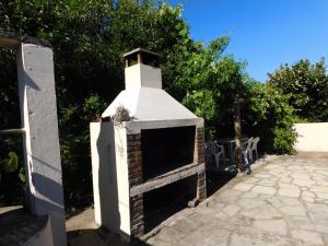 a brick oven sitting on top of a patio at Arcoiris in La Coronilla