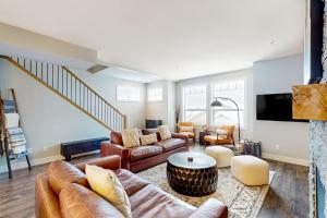 a living room with a couch and a table at Bear Cave- Grizzly Ridge 260A in Big White