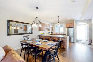 a dining room and kitchen with a table and chairs at Bear Cave- Grizzly Ridge 260A in Big White +10 photos