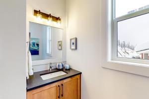 a bathroom with a sink and a window at Bear Cave- Grizzly Ridge 260A in Big White