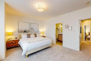 a bedroom with a large white bed in a room at Bear Cave- Grizzly Ridge 260A in Big White