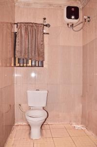 a bathroom with a white toilet in a room at Trending Place Hotel and Suites in Lagos