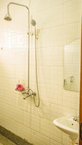 a bathroom with a shower and a sink at Serene villa in Jinja