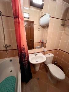 y baño con aseo, lavabo y bañera. en 1-bedroom deluxe condo in Pamporovo, en Pamporovo