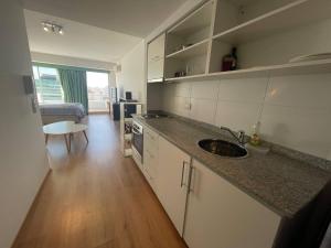 a kitchen with a sink and a counter top at Studio Apartment on 13th Floor Above 9 de Julio Avenue in Buenos Aires