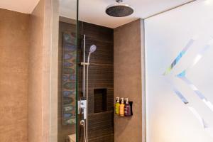 a shower in a bathroom with a glass door at Holiday Inn Resort Phuket Karon Beach, an IHG Hotel in Karon Beach