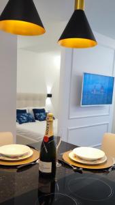 a bottle of champagne on a table in a room at A1.0 - Alexa Smart house in Braga