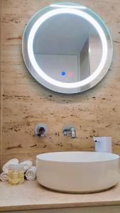 a bathroom sink with a mirror on a wall at A1.0 - Alexa Smart house in Braga