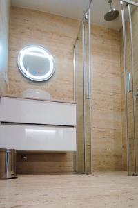 a bathroom with a sink and a shower at A1.0 - Alexa Smart house in Braga