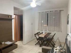 a dining room with a table and chairs in a room at Onix Sol e Piscina in Campos dos Goytacazes